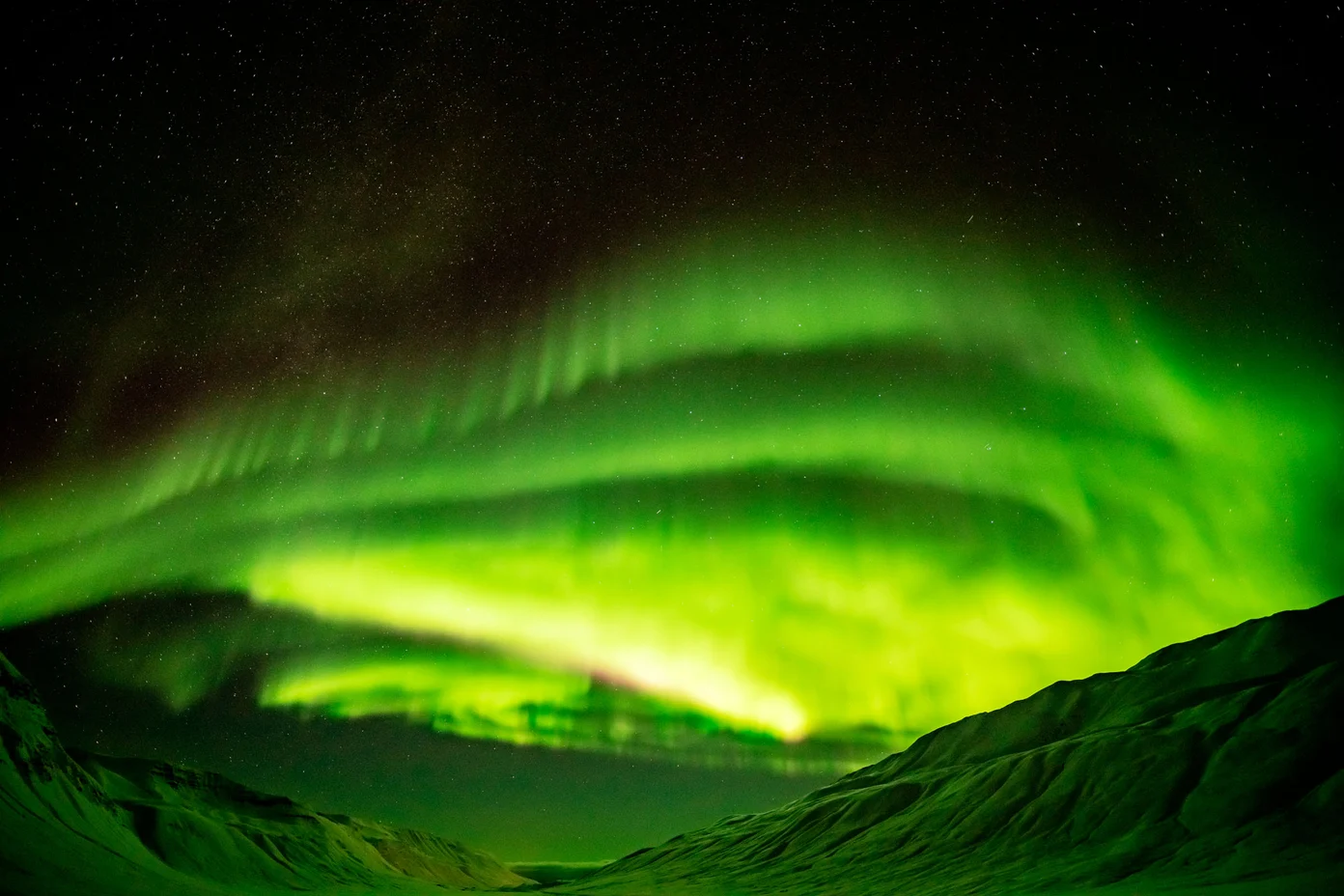 Northern Lights over snowy mountains