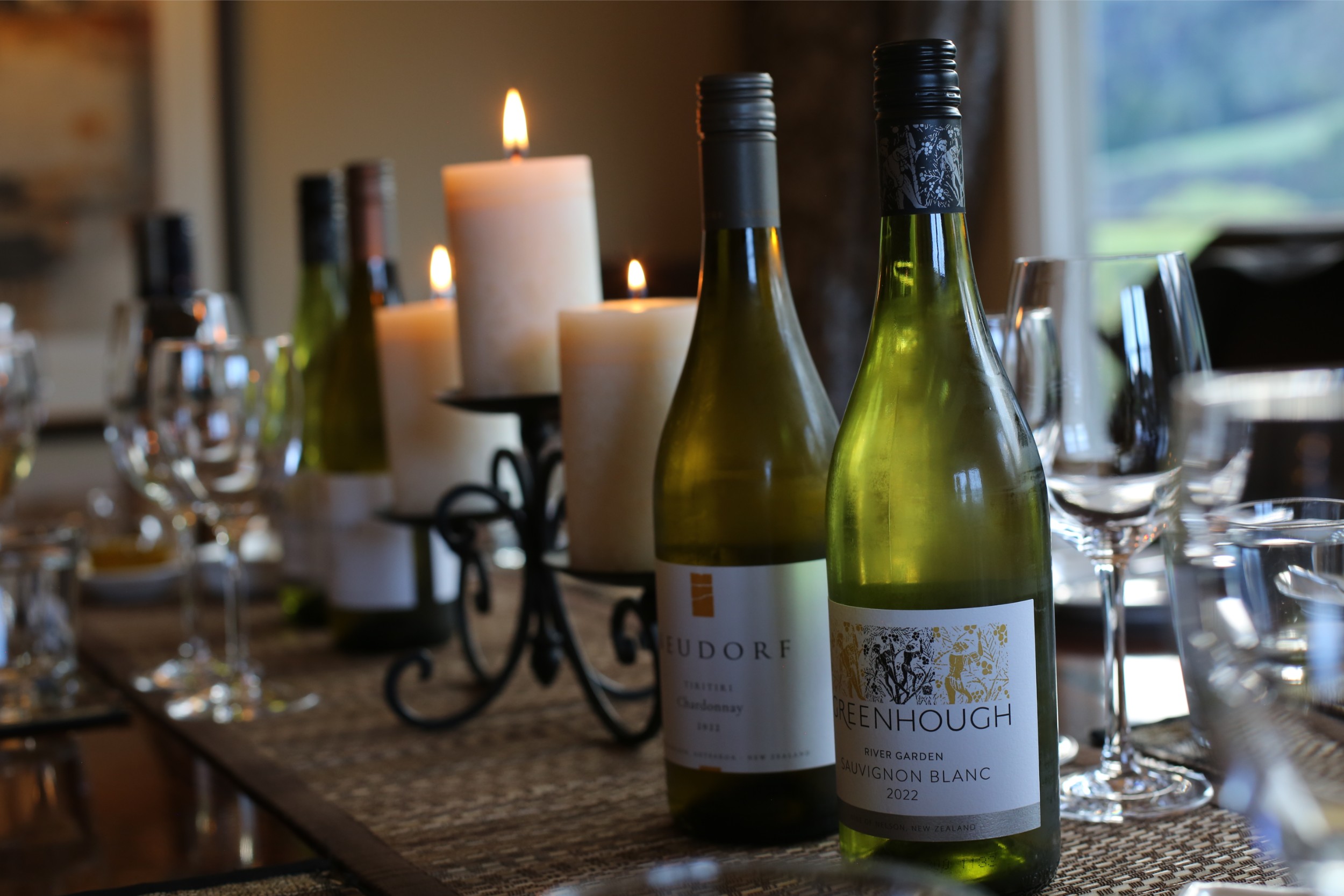 Two bottles of local New Zealand wine on a table ready for tasting.