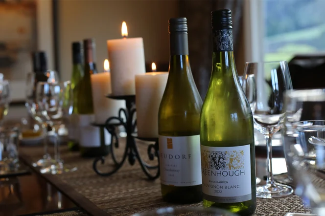 Two bottles of local New Zealand wine on a table ready for tasting.