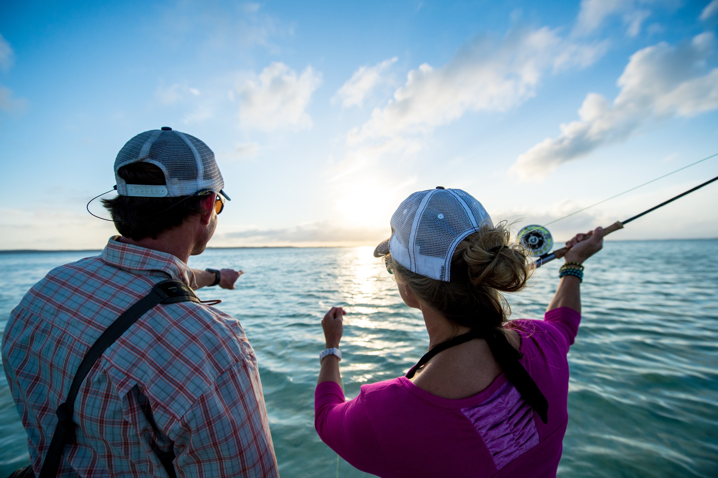 A guide instructs an angler on casting.