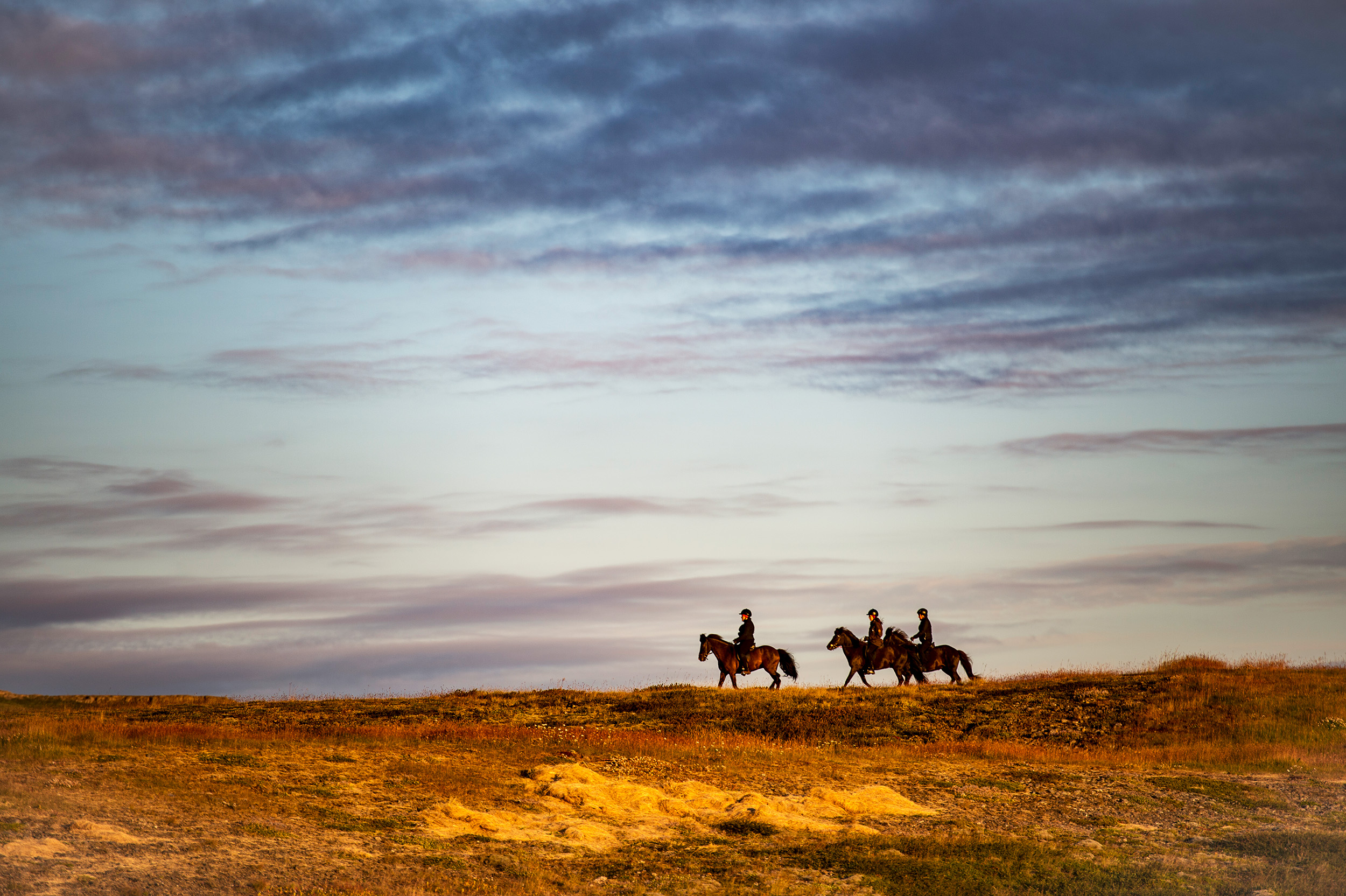 People riding horses in Iceland.