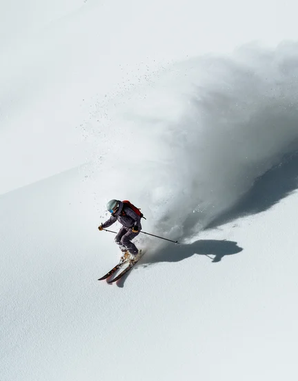 A person skiing down steep French Alp.