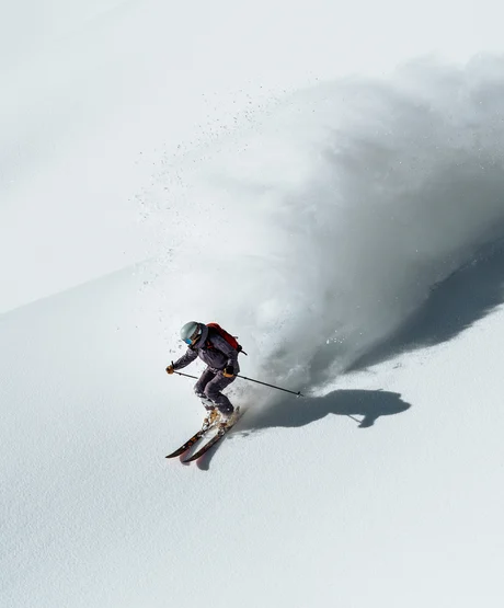 A person skiing down steep French Alp.
