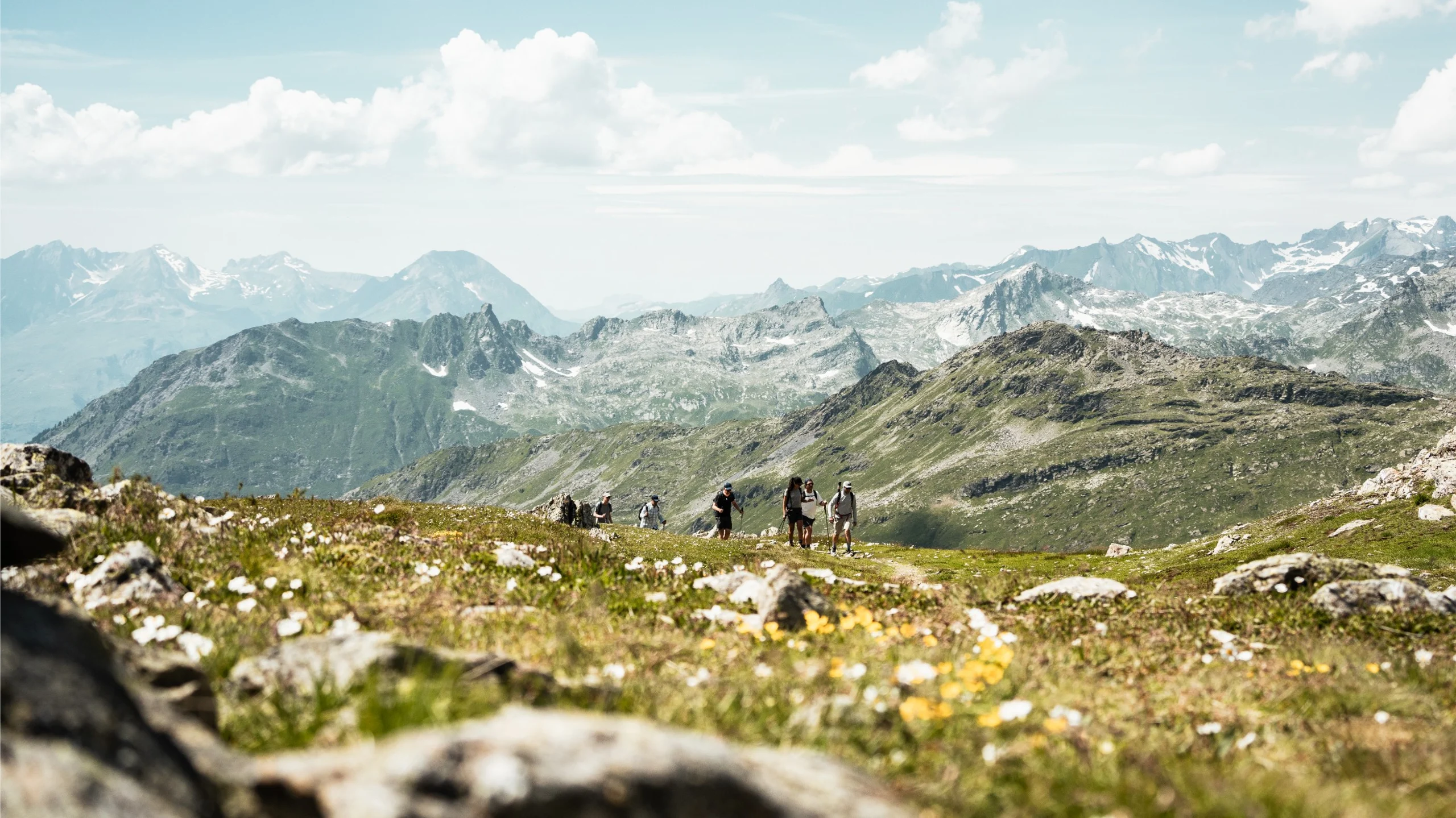 Hikers walking through a lush winter valley in France.