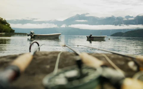 Fly fishing rods in front of the Patagonia scenery and boats