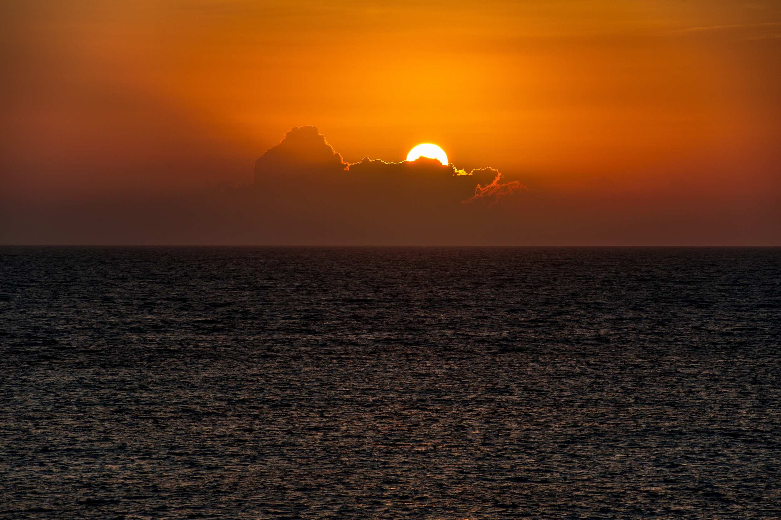The sun sets over the ocean in the Bahamas.
