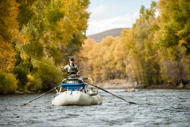 An angler casts from a boat on the Gunnison River
