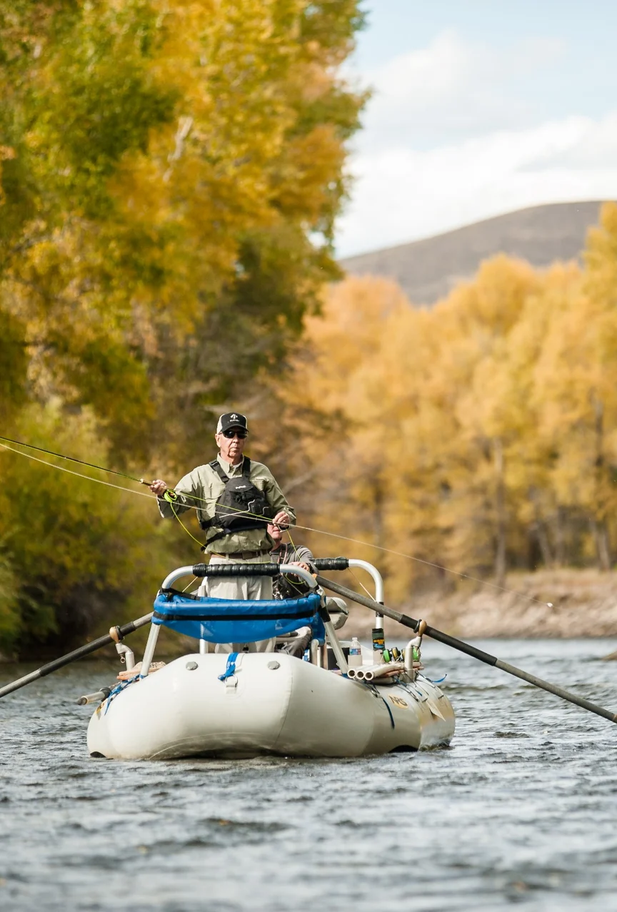 An angler casts from a boat on the Gunnison River