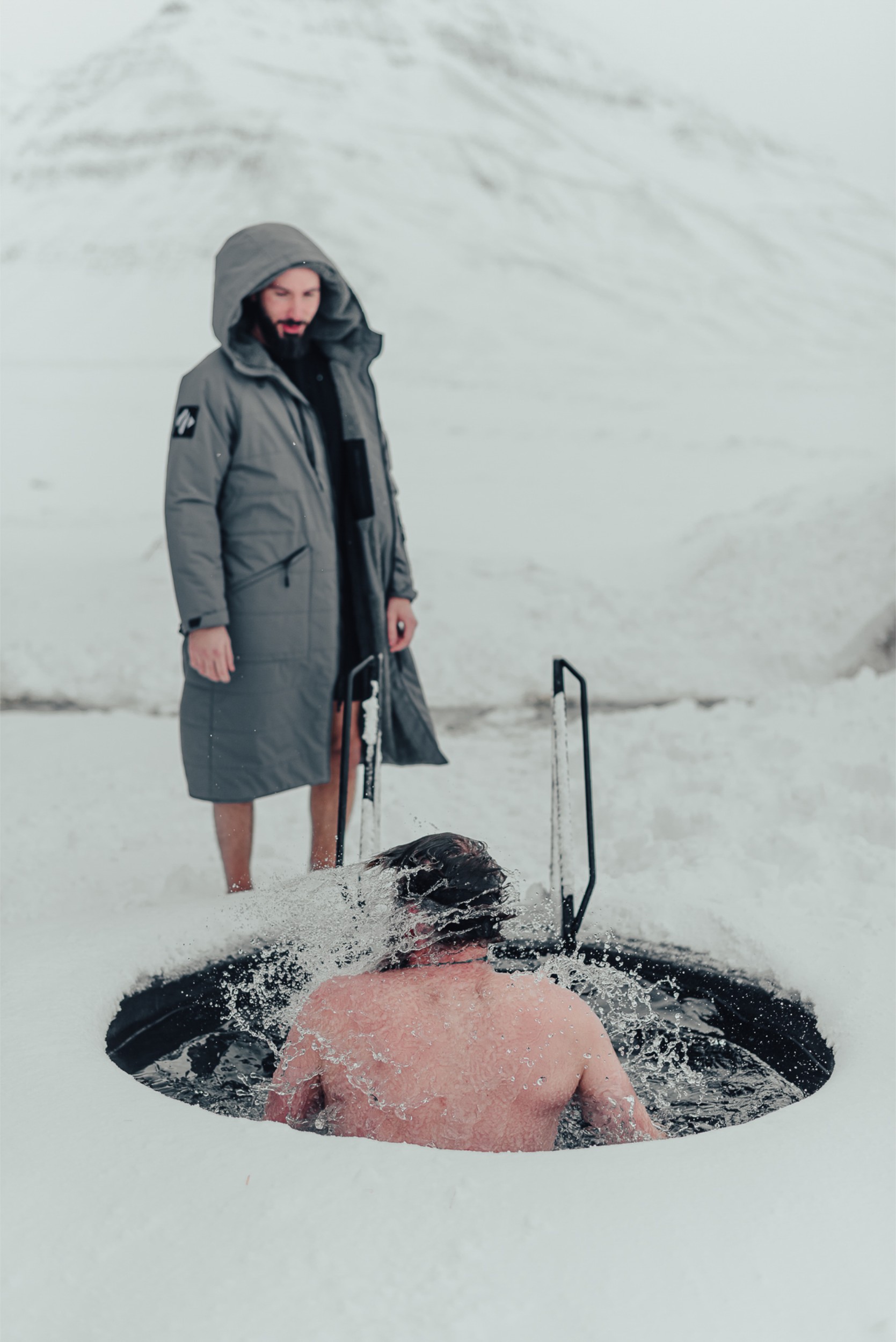 A person taking an ice plunge during a Viking Ritual in Iceland.