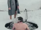 A person taking an ice plunge during a Viking Ritual in Iceland.