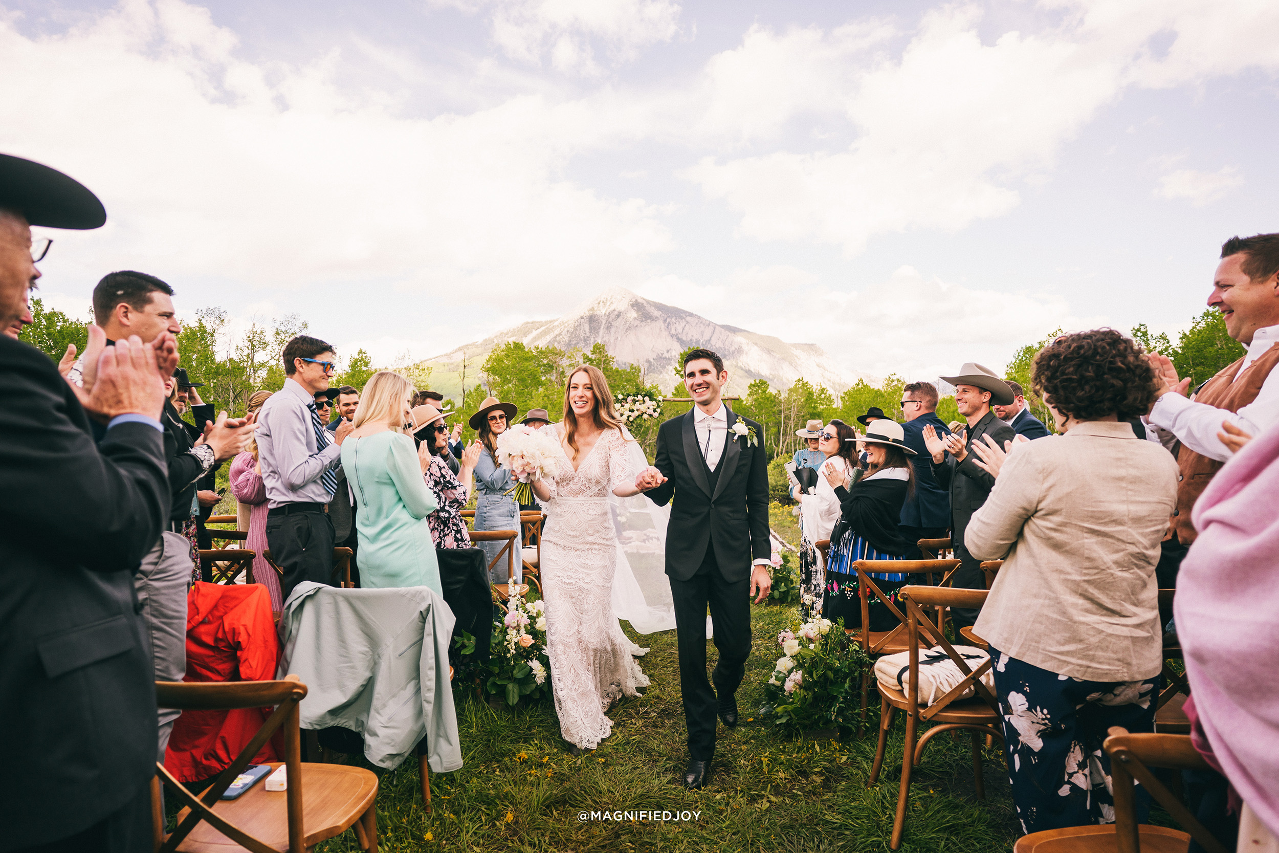 Couple walking down the aisle at Sopris House.
