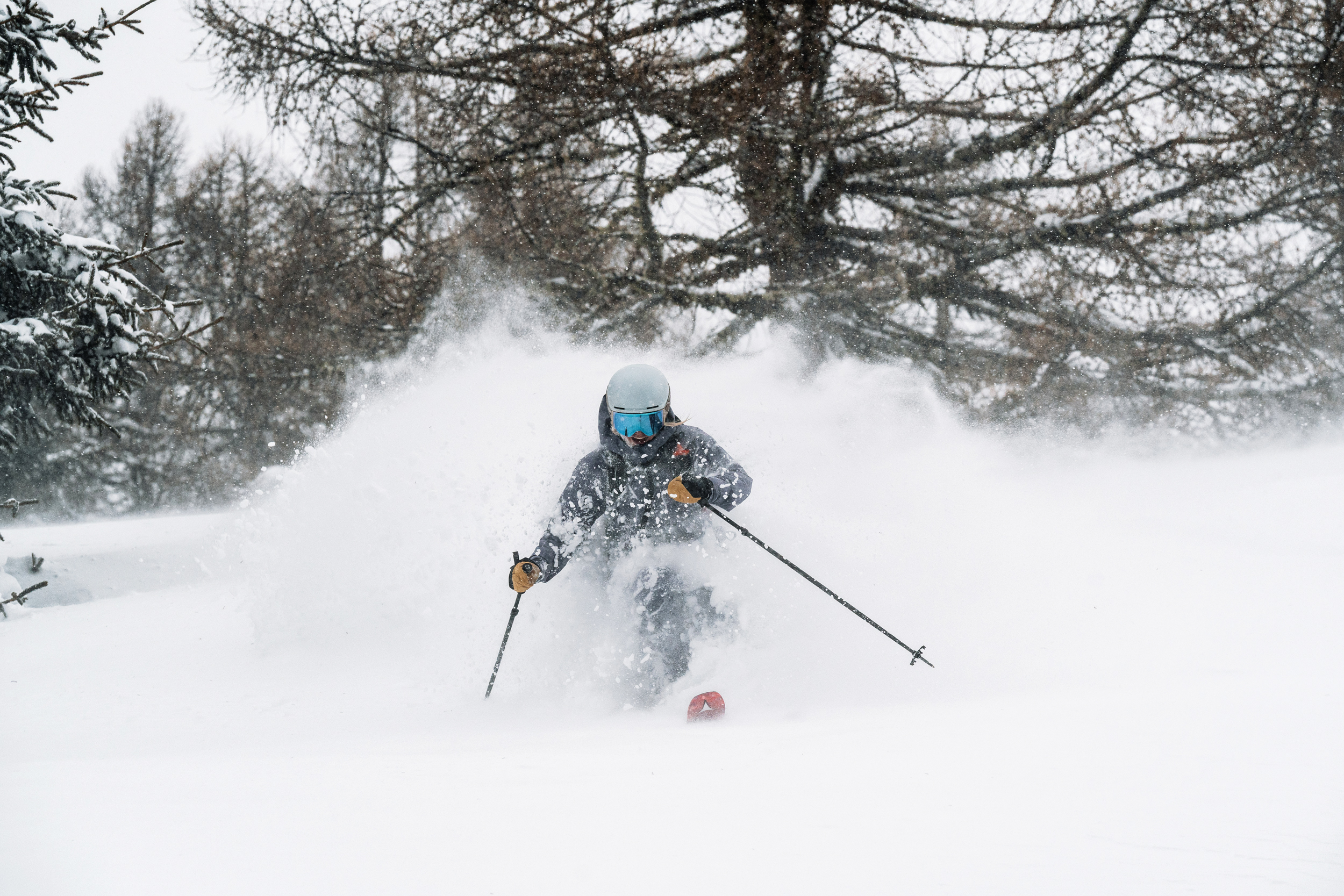A skier turning at high speeds on a mountain top.