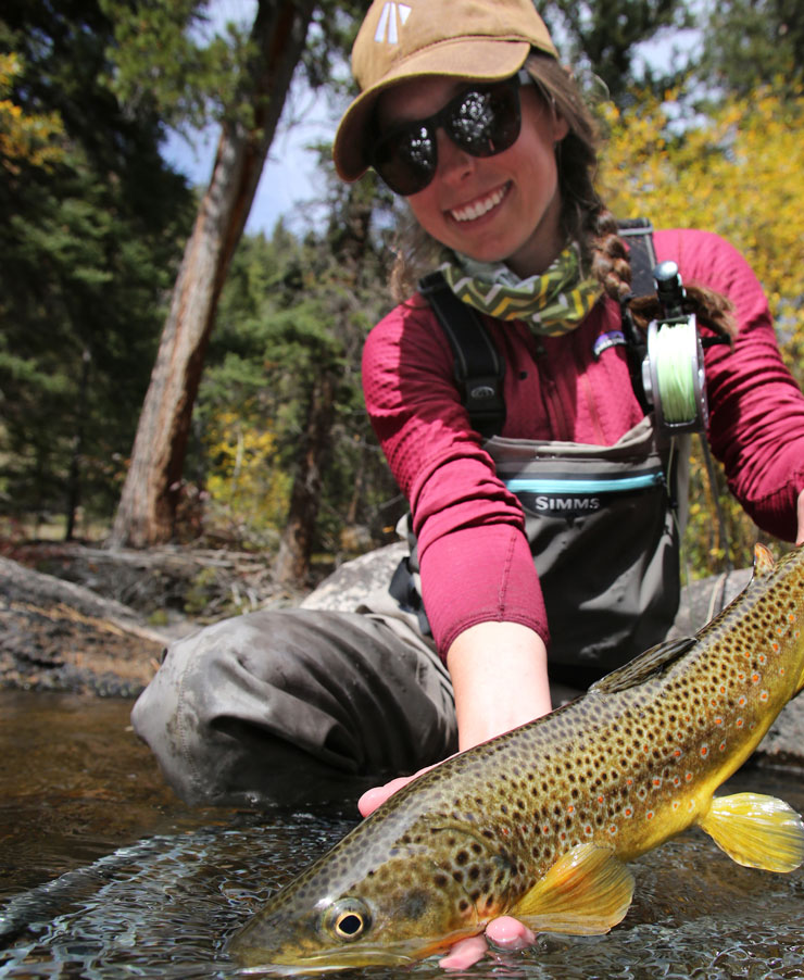 An angler shows off a brown trout.