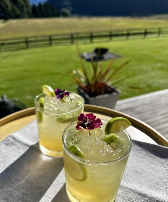 Lime cocktails on a table outdoors.