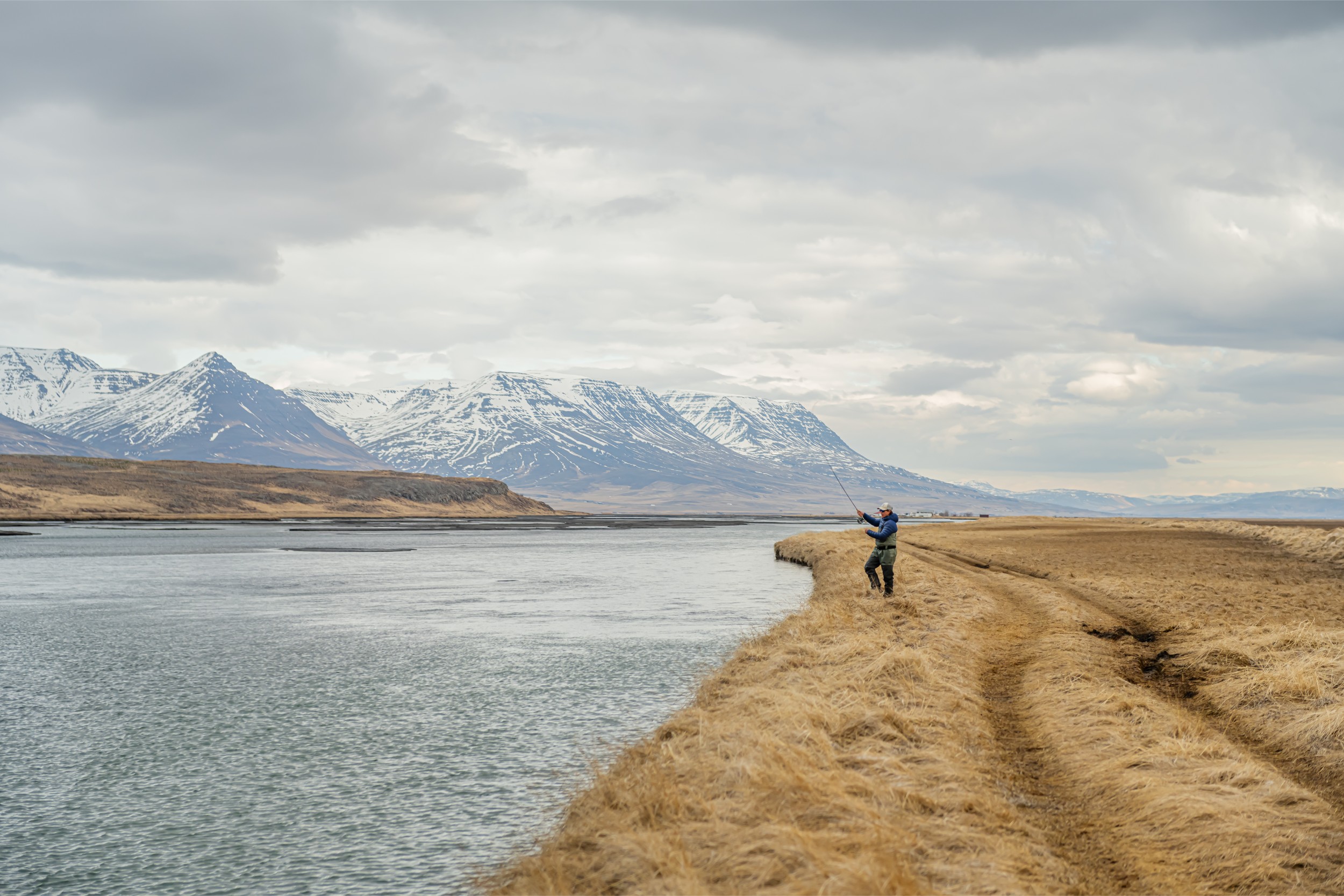A fisher at river's edge in Iceland.