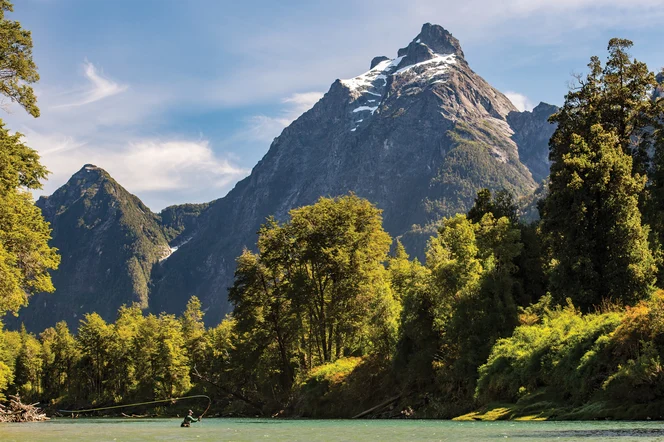 A fly fisher in a river in Chile.