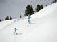 A group of kids skiing down a beginner's slope.