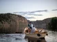 Angler fights a fish from a boat on the Gunnison River.