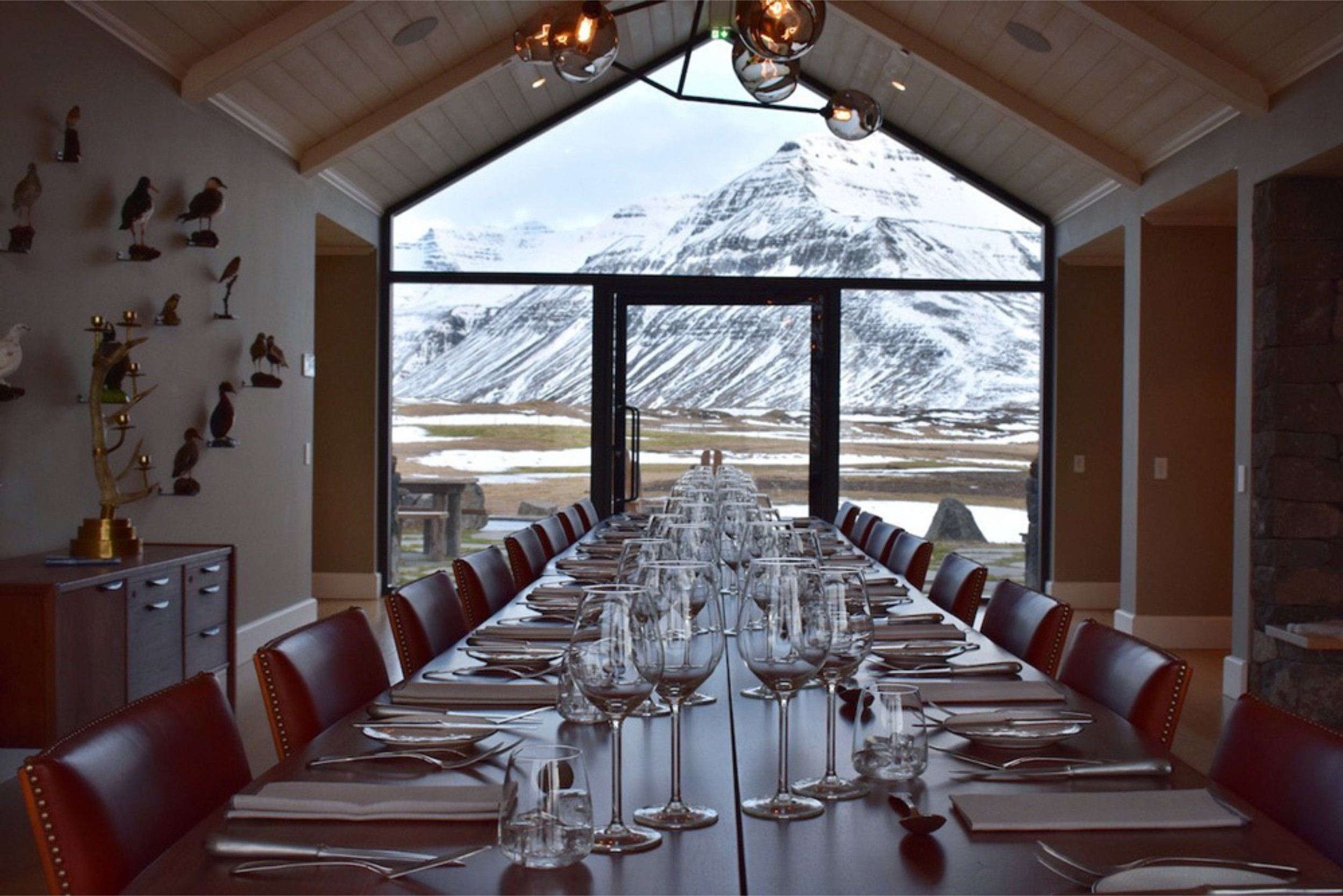 A large dining table in Deplar Farm with views of Icelandic Mountains