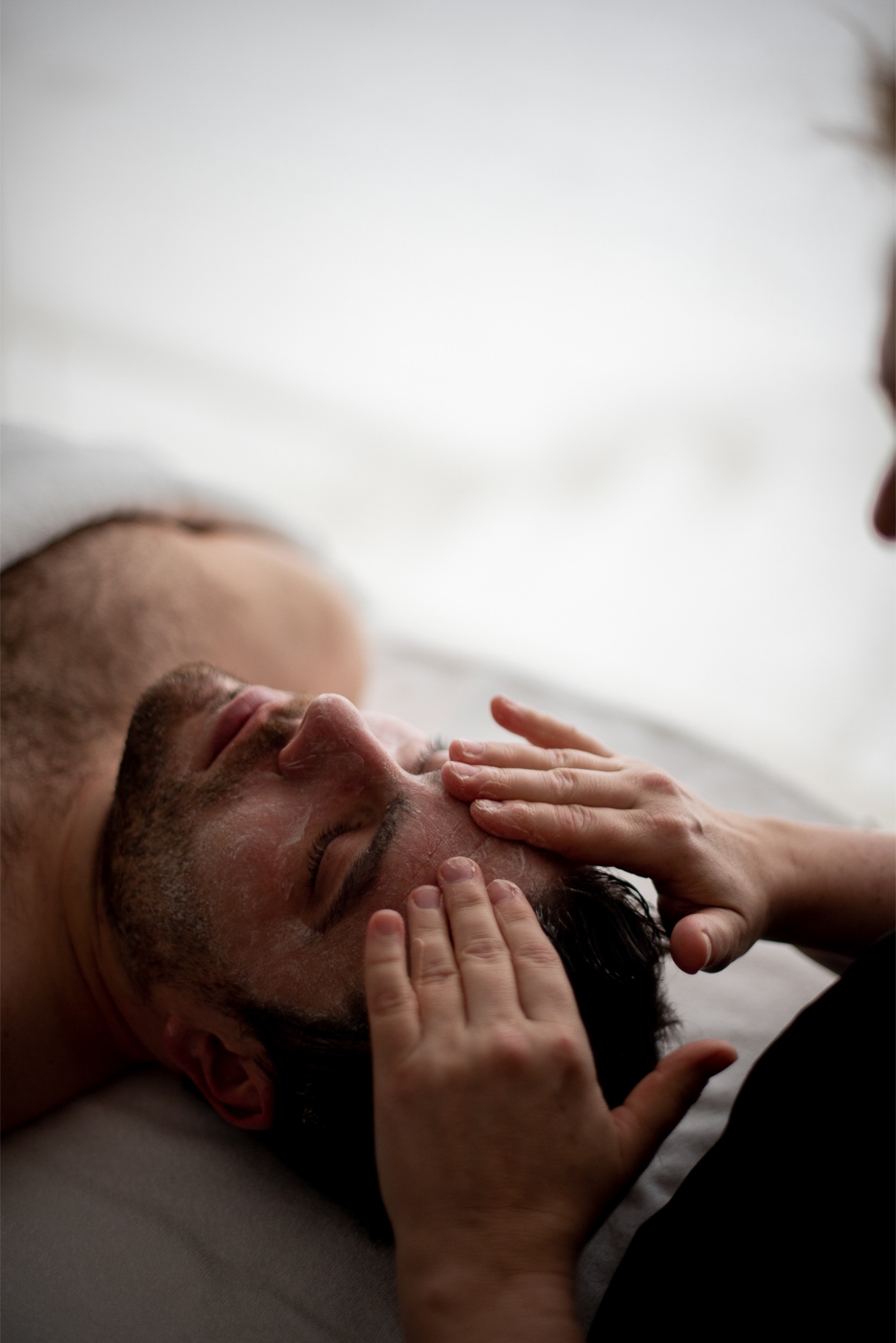 A man receiving a facial massage in the spa at Deplar Farm.