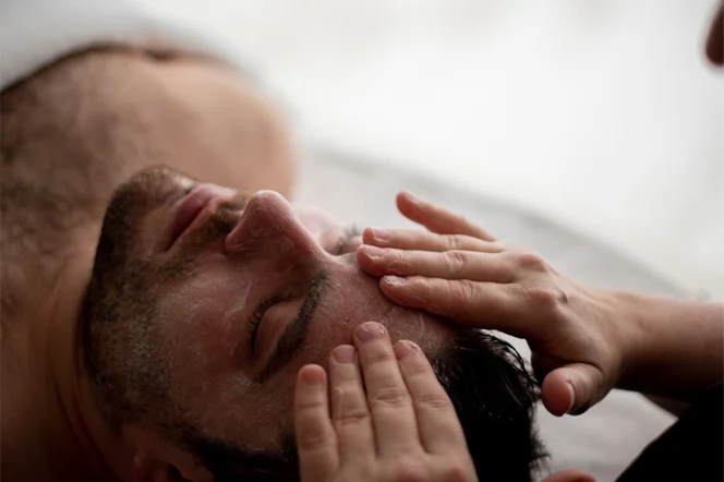 A man receiving a facial massage in the spa at Deplar Farm.
