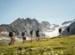 Summer hikers walking to a glacier in the alps.