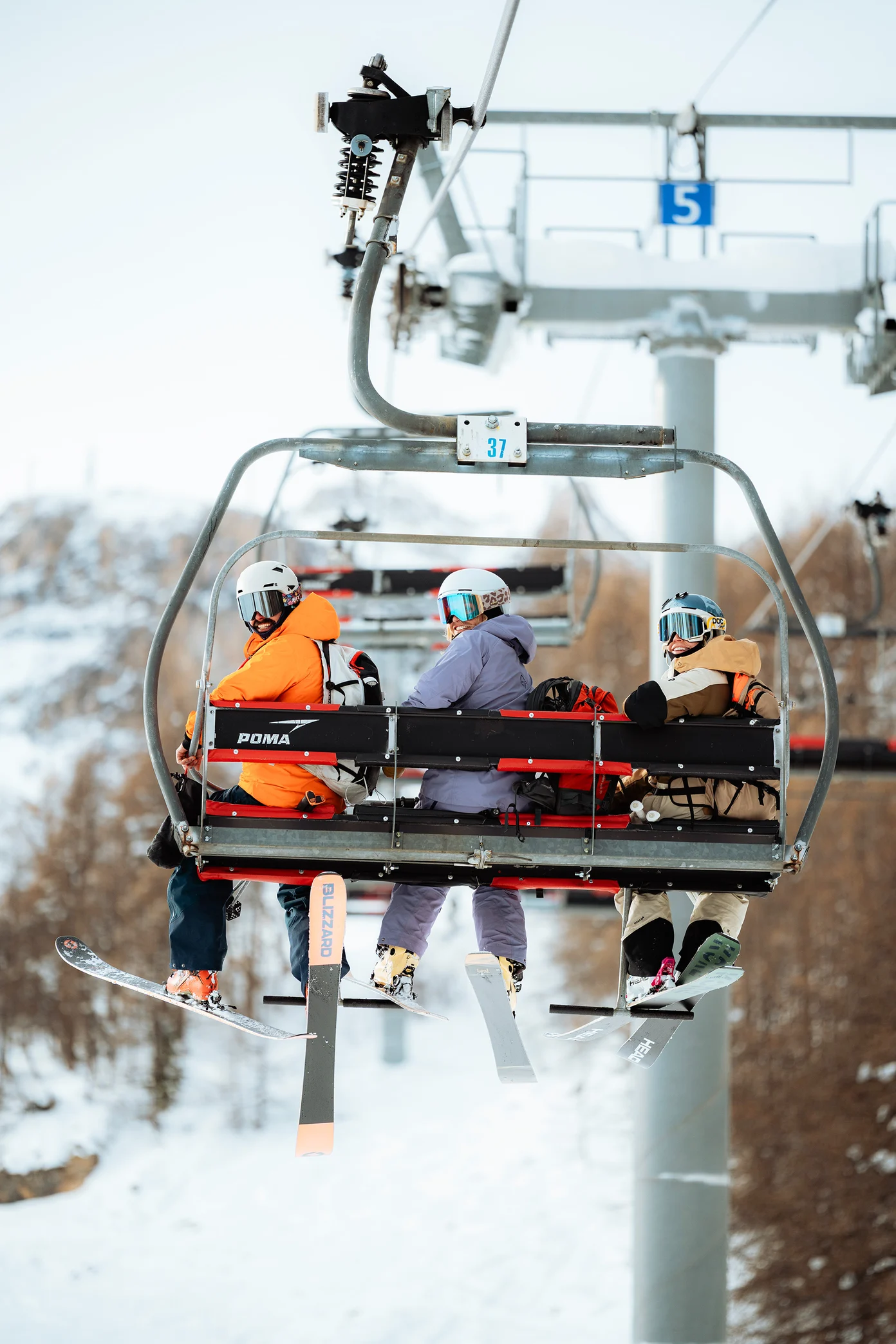 Skiers on chairlift in France
