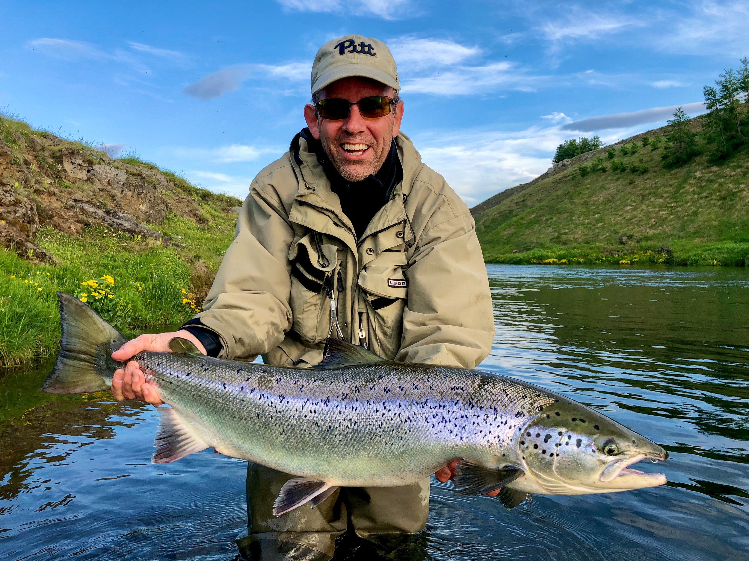 A person holding a large Atlantic Salmon.