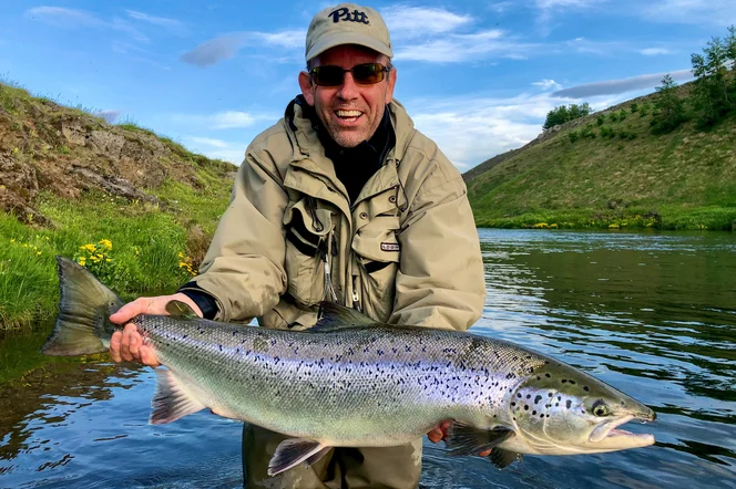 A person holding a large Atlantic Salmon.