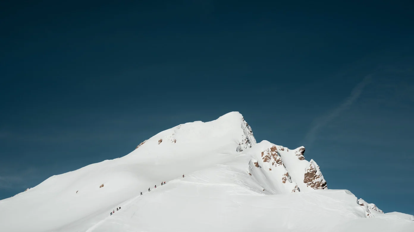 Skiers tour through the French Alps.