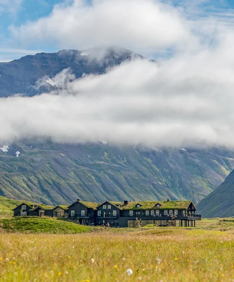 A view of Deplar Farm and the surrounding green mountainous valley.