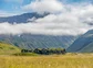 A view of Deplar Farm and the surrounding green mountainous valley.