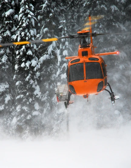 Helicopter taking off in BC backcountry