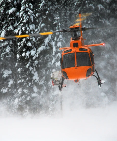 Helicopter taking off in BC backcountry