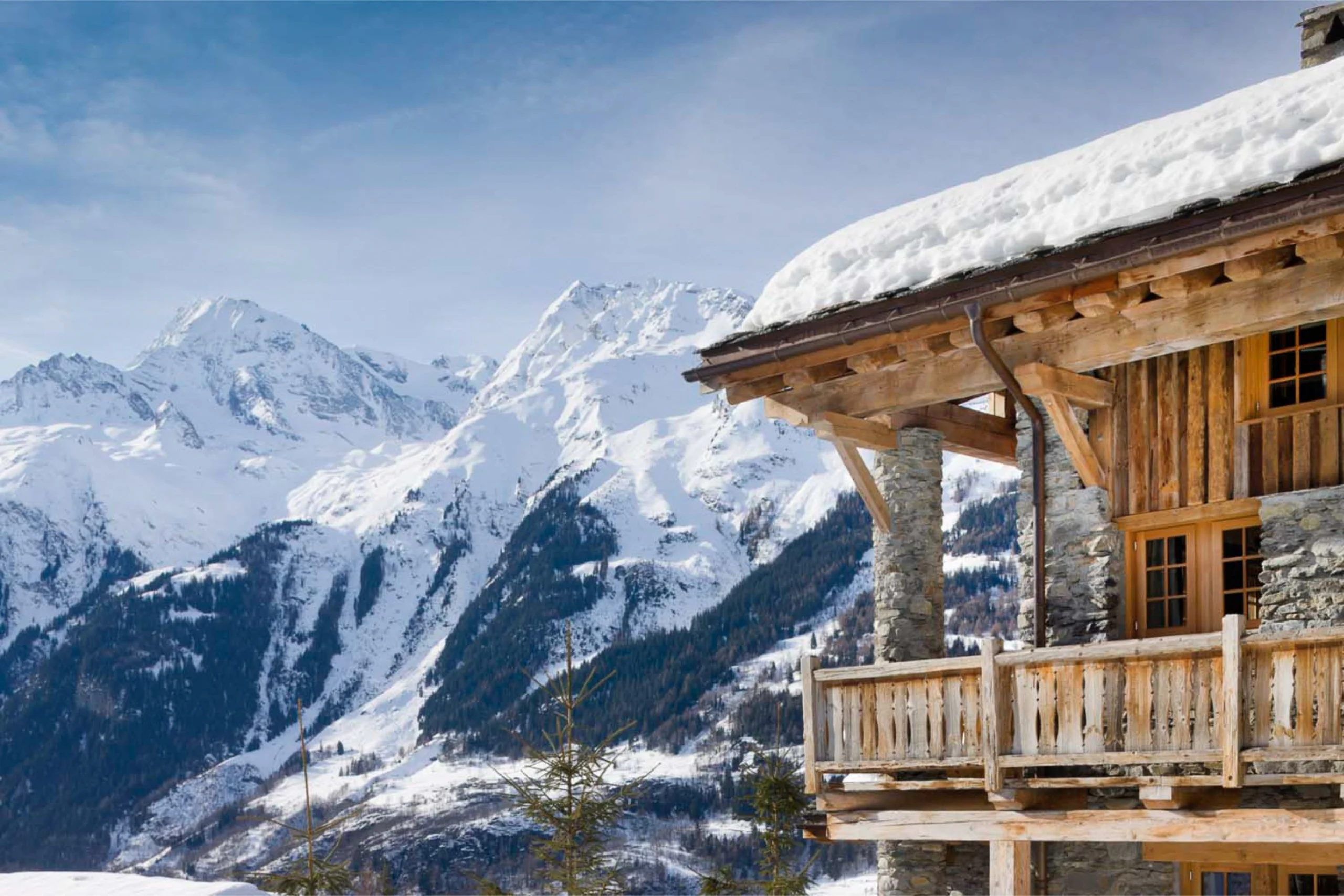 The deck of Chalet Pelerin from outside with snow covered Alps in the distance.