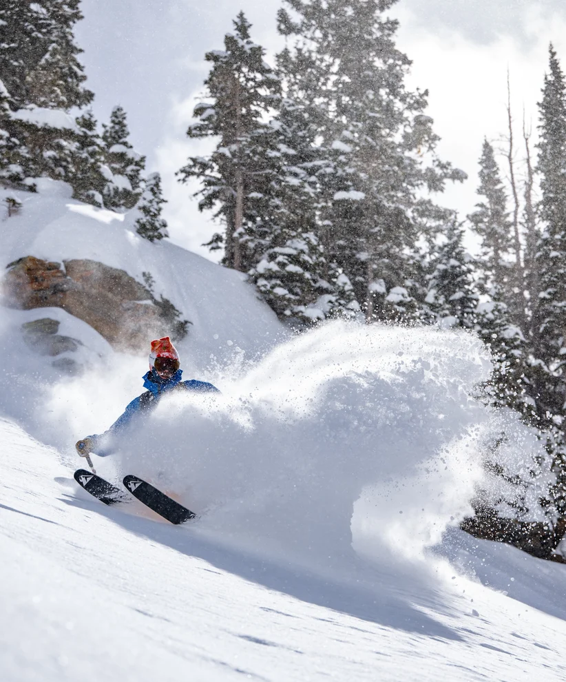 A skier skidding to a stop head downhill on Mount Irwin.