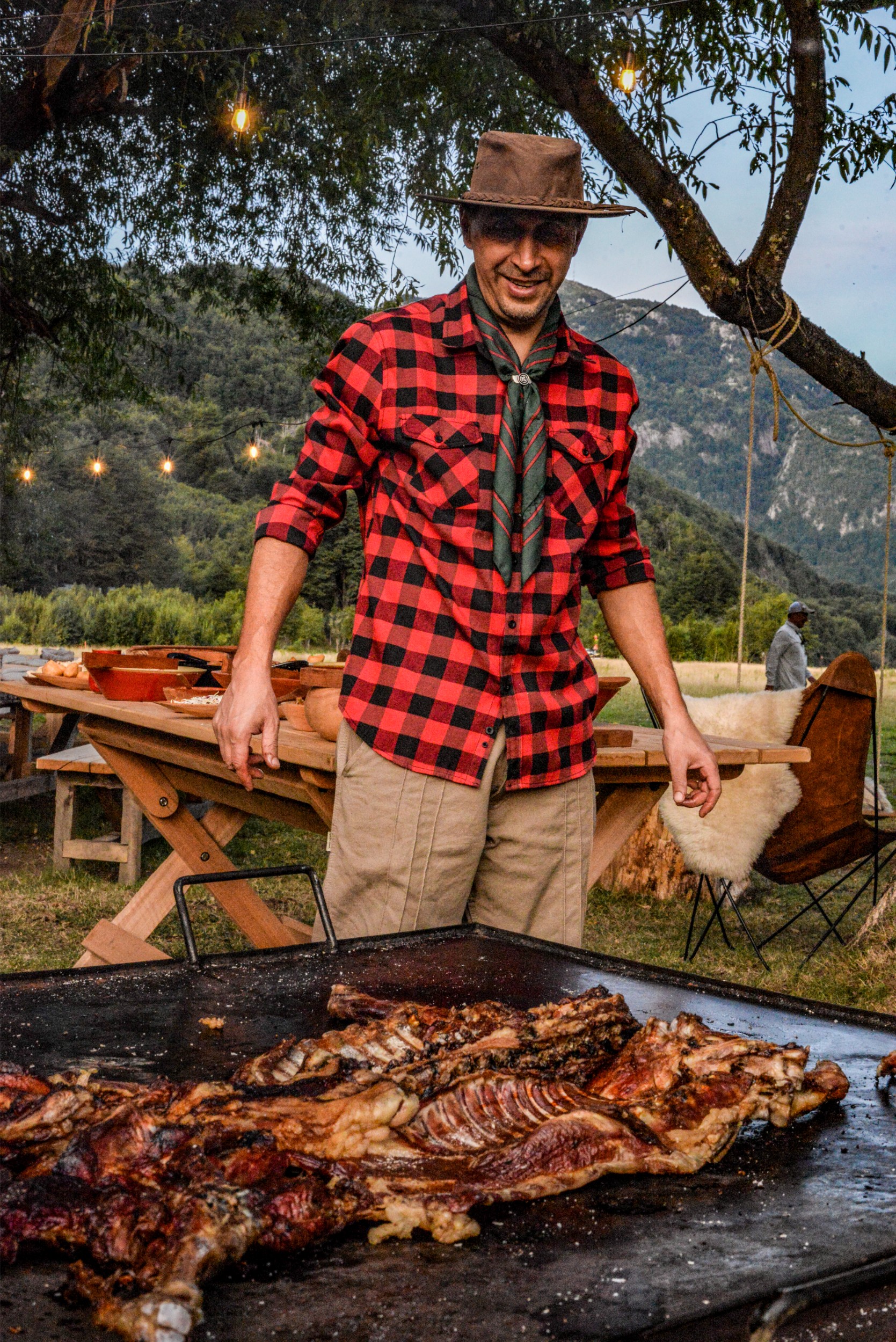 Meat being roasted on a large Asado grill by local Chilean chef.