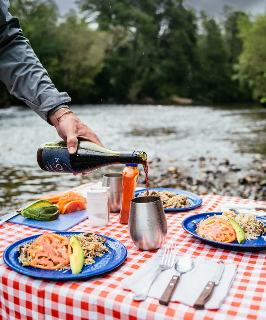Fresh made lunch and wine being served river side.