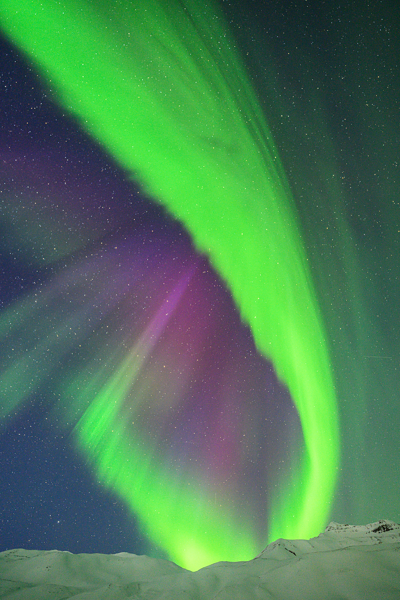 Northern Lights above mountains in Iceland.