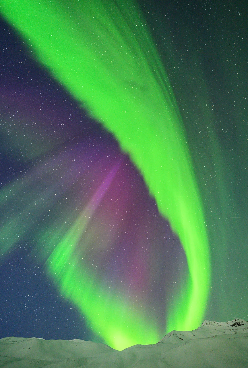 Northern Lights above mountains in Iceland.