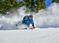 A woman smiling while skiing in Colorado.