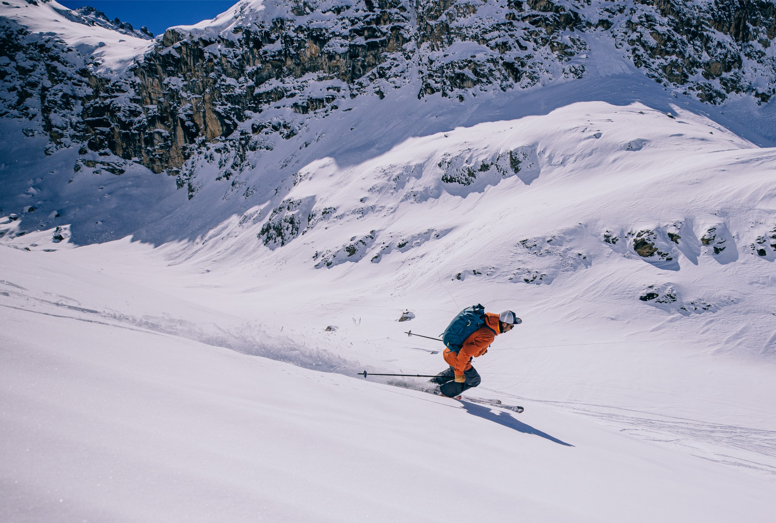 A skier headed down a mountain.