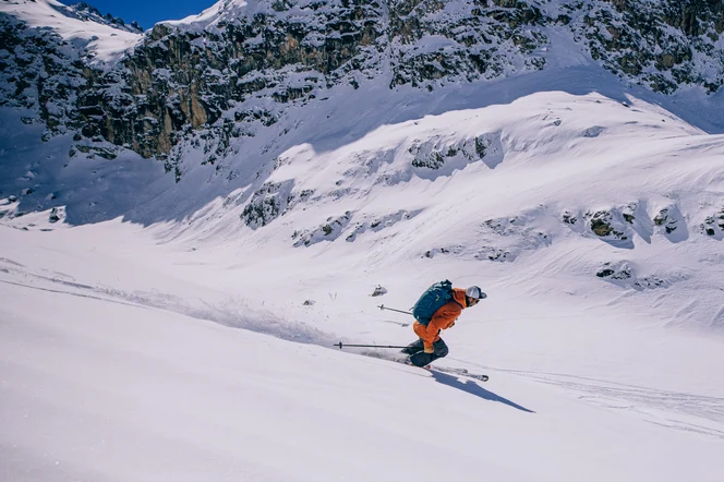 A skier headed down a mountain.