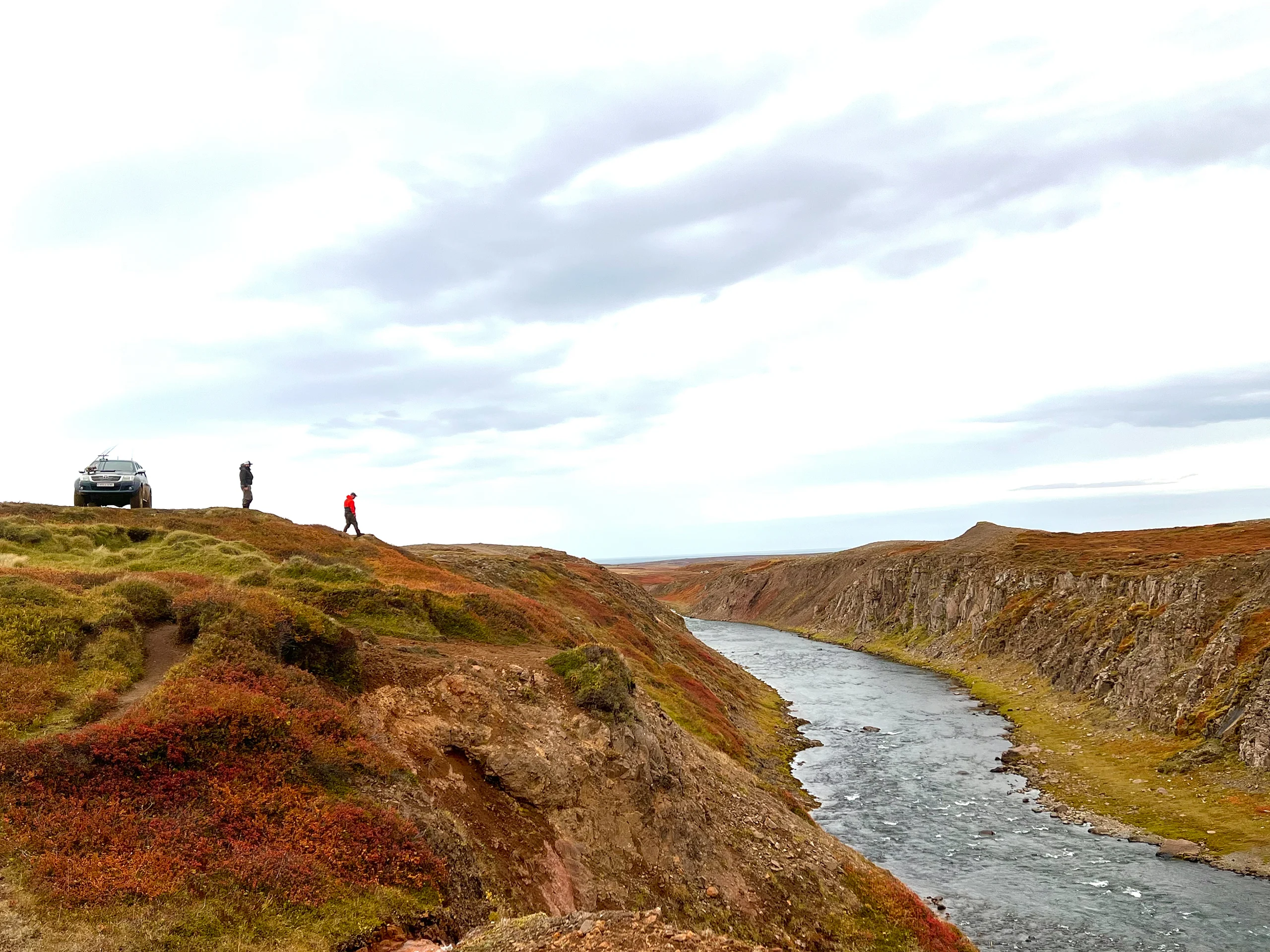 Anglers assess the Holkna River from its banks in Iceland.