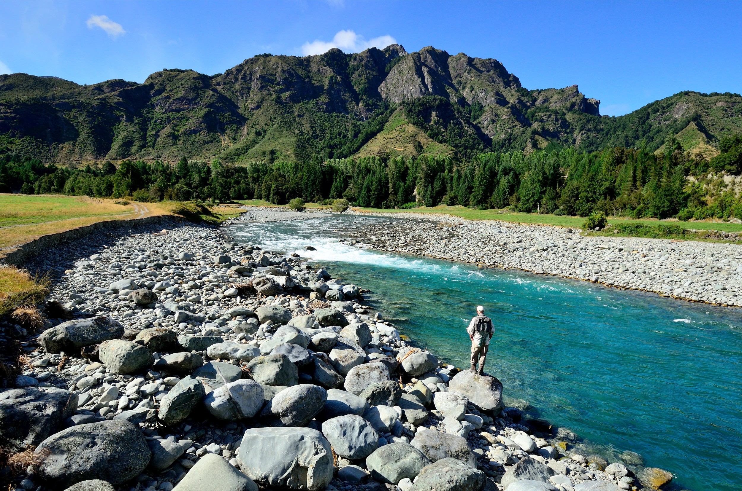 A fisher casting a line in Owen River.