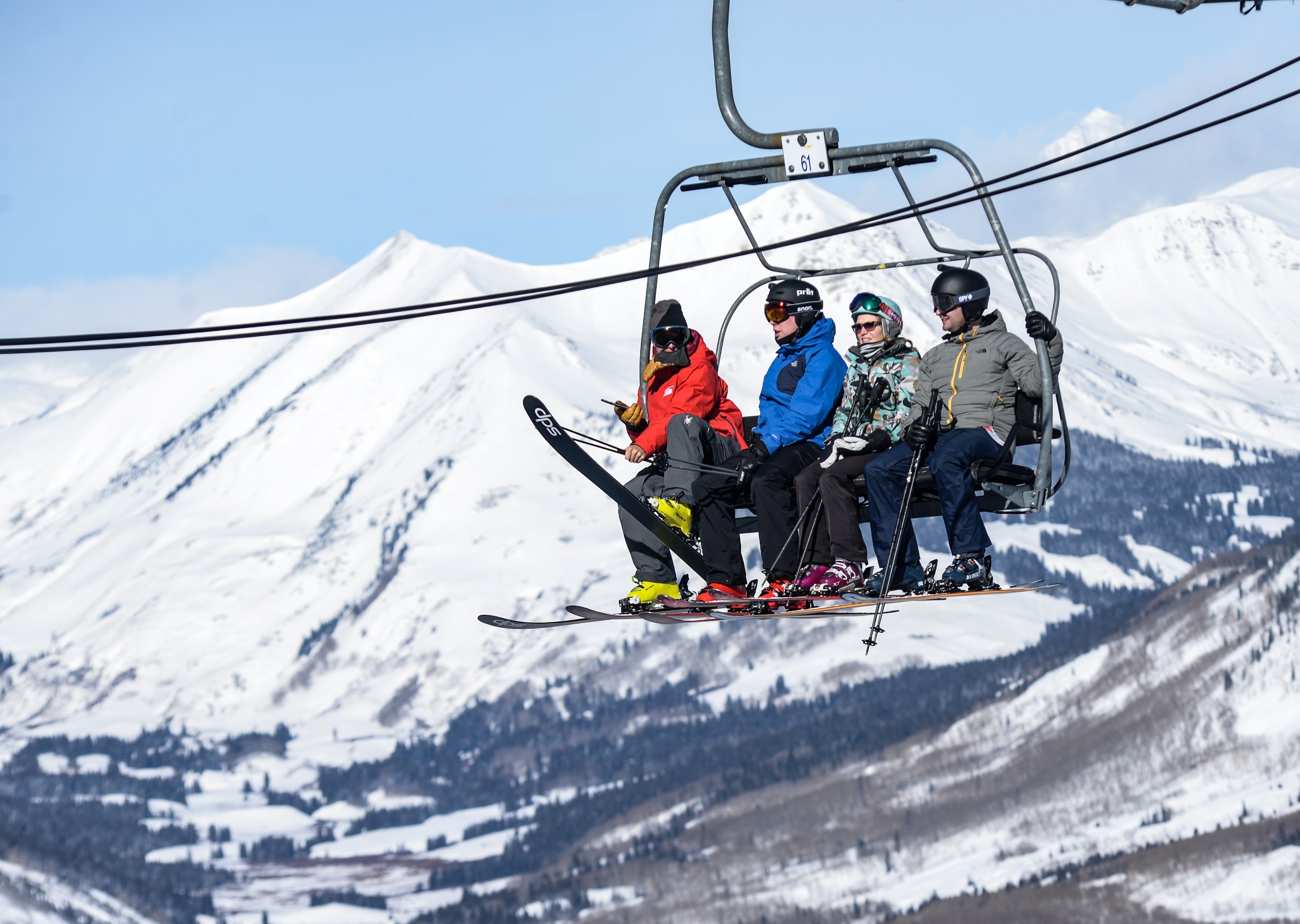 A group of friends on a ski lift.