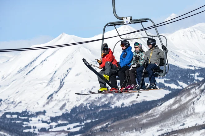 A group of friends on a ski lift.
