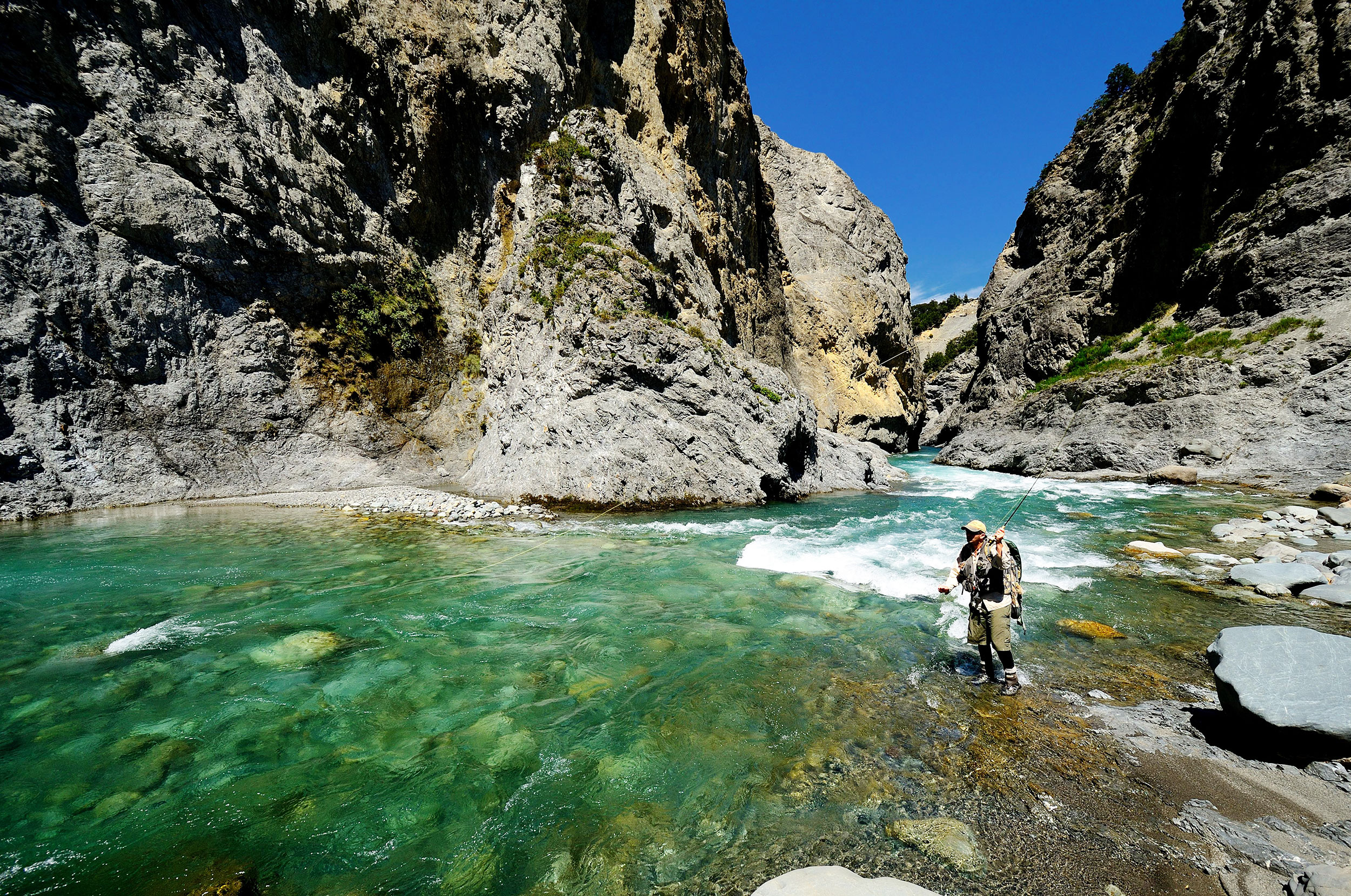 Man angling in a remote New Zealand river