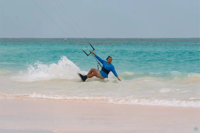 A person kite surfing on a beach in the Bahamas.