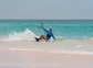 A person kite surfing on a beach in the Bahamas.